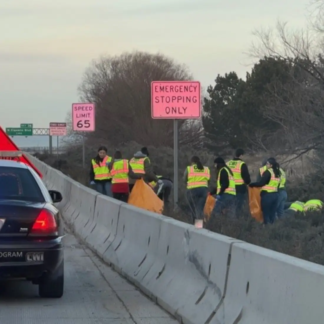 Students on the side of road picking up trash