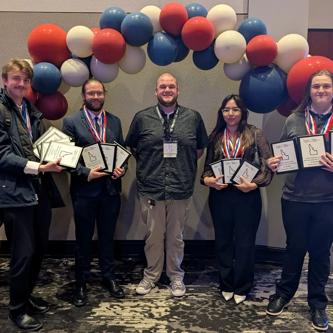 Business Professionals of America students and faculty stand with their awards