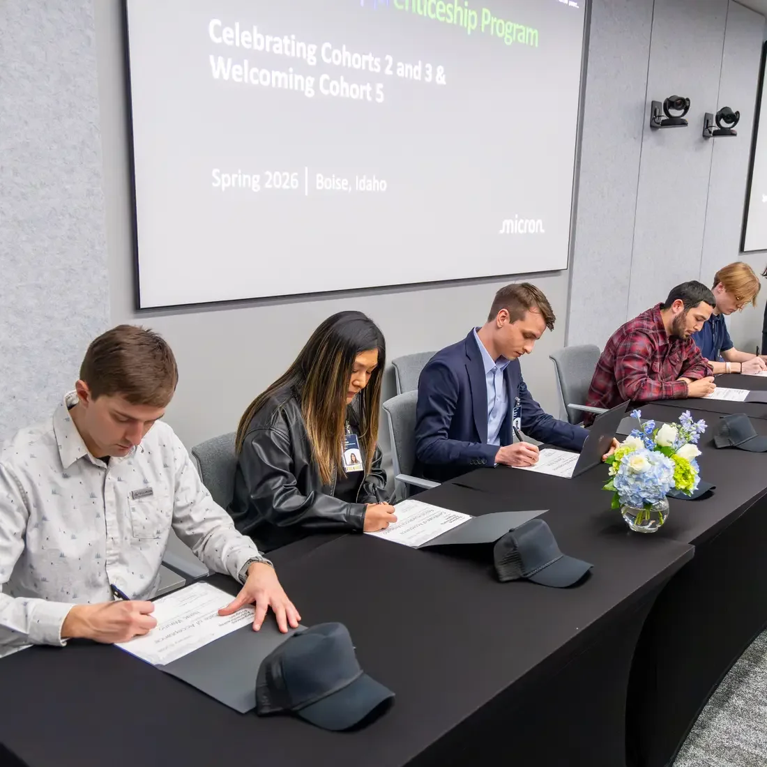 Group of people signing a paper