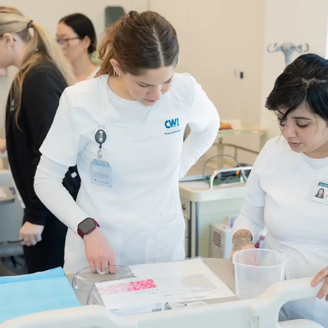 Two nursing students looking at material