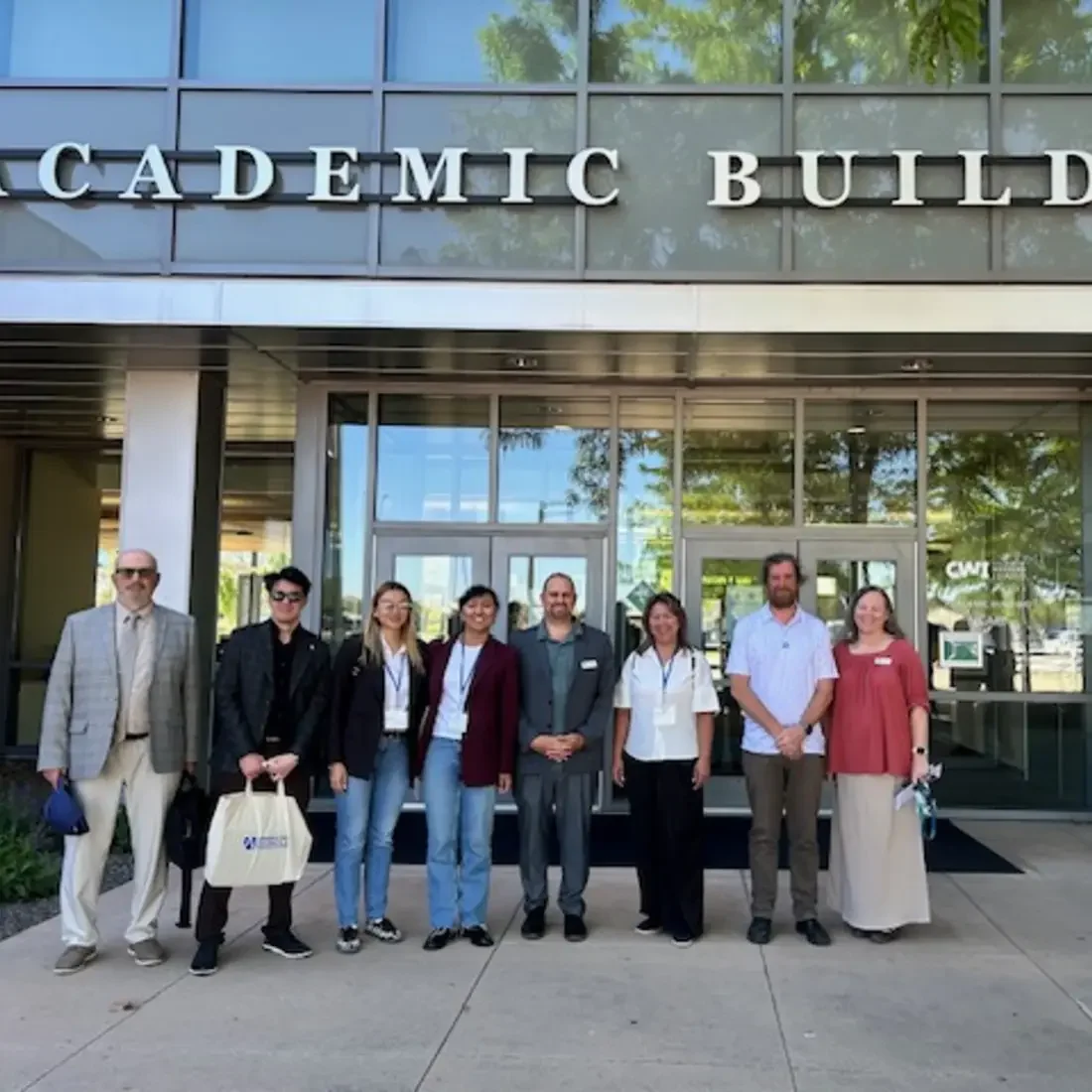 Group of CWI and Kazakhstan leaders in front of Academic Building