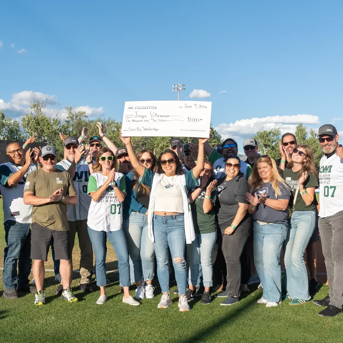 Group picture of CWI community with center person holding large check