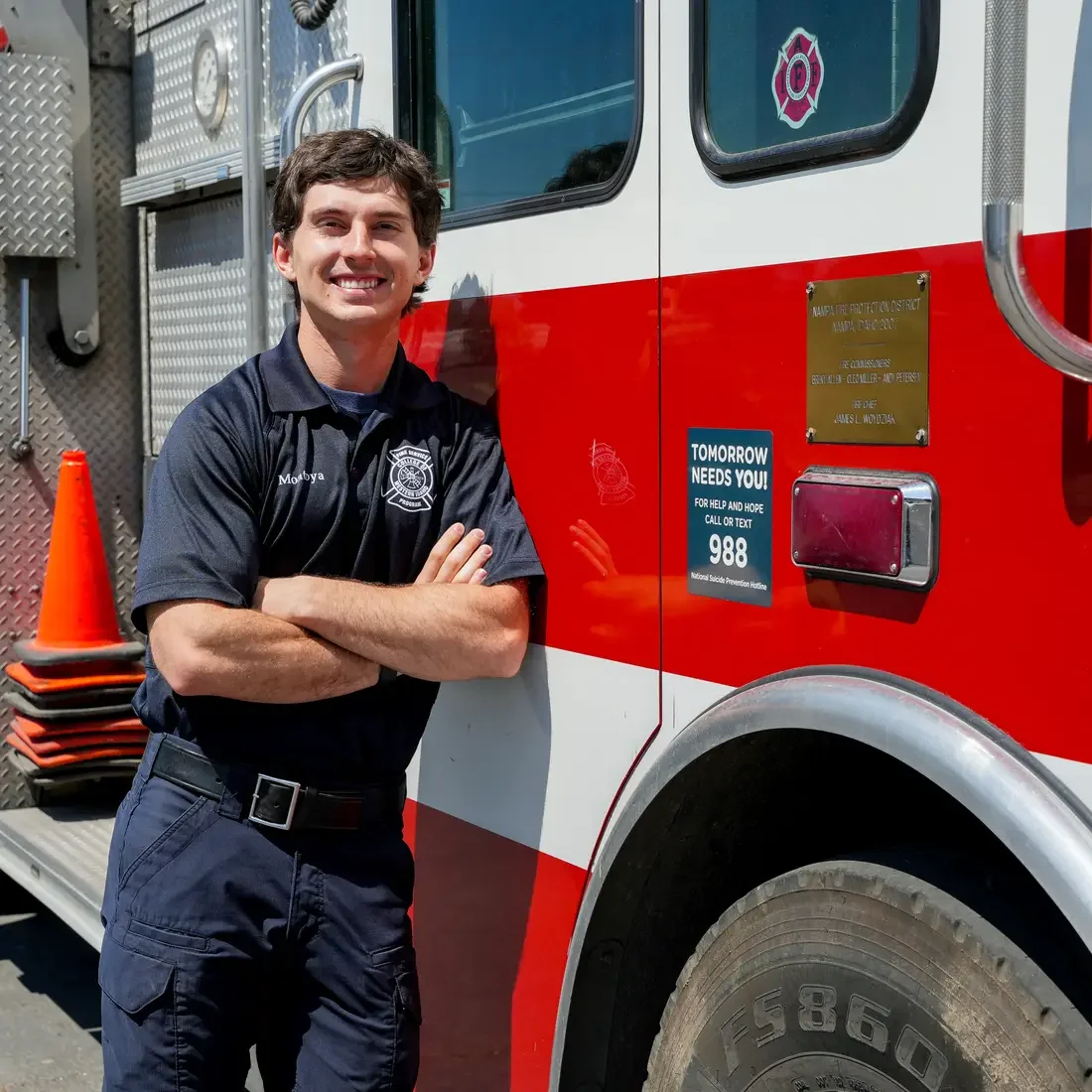 Khye Montoya leans on fire truck