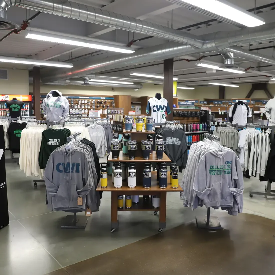 Shirts, sweaters, cups on display at Bookstore