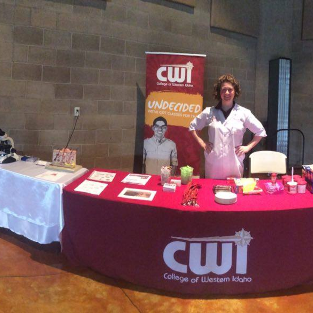 Faculty member at a table sharing about programs