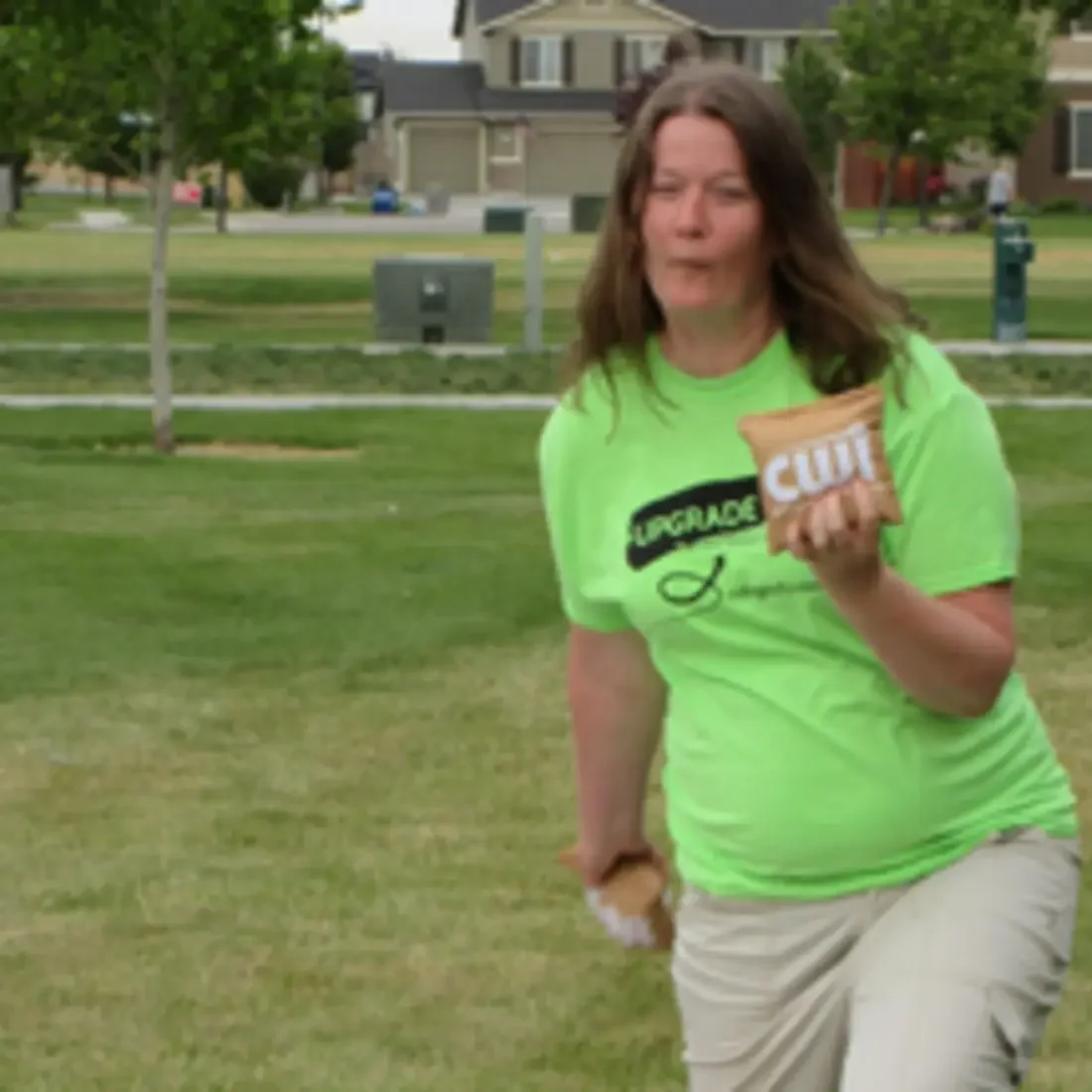 Student wearing CWI Upgrade t-shirt playing cornhole