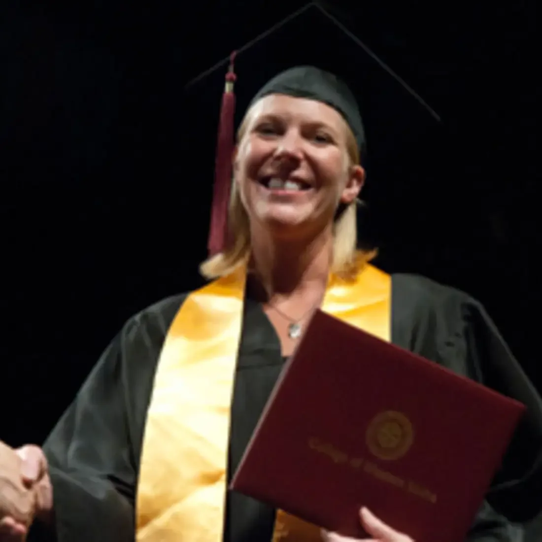 Student on stage at commencement