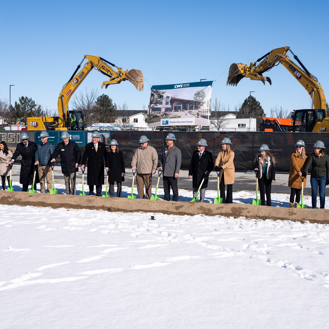 Dignitaries stand with shovels for a ceremonial groundbreaking.
