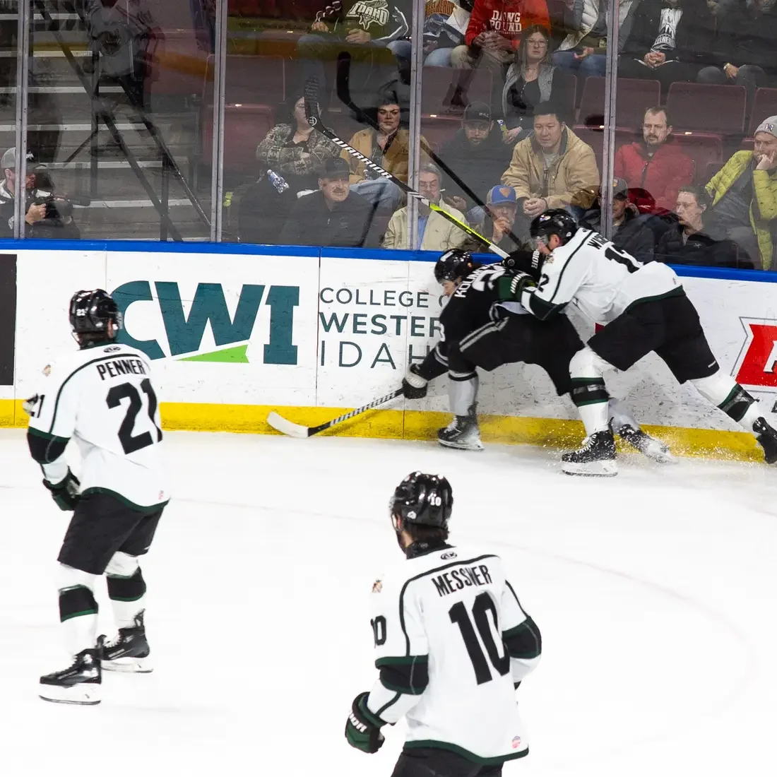 Hockey players race for the puck.