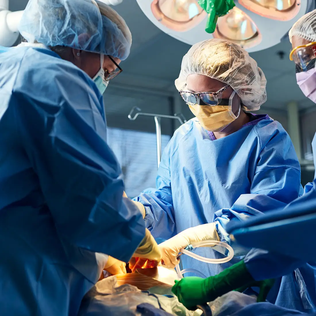 Surgical technicians assist during a medical surgical procedure.