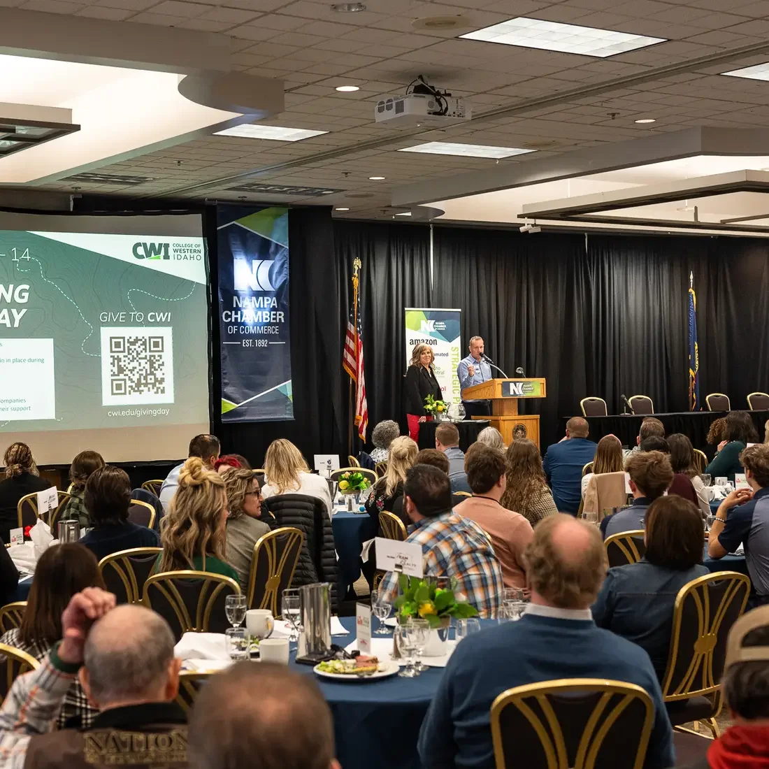 People listen to a speaker during a chamber of commerce luncheon.