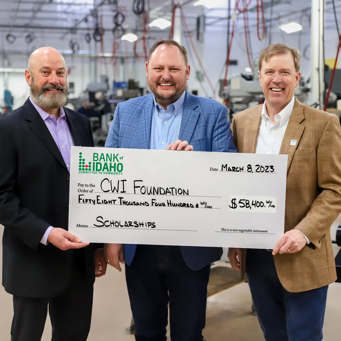 Mike Pena, Jeff Newgard, and Gordon Jones hold Bank of Idaho check
