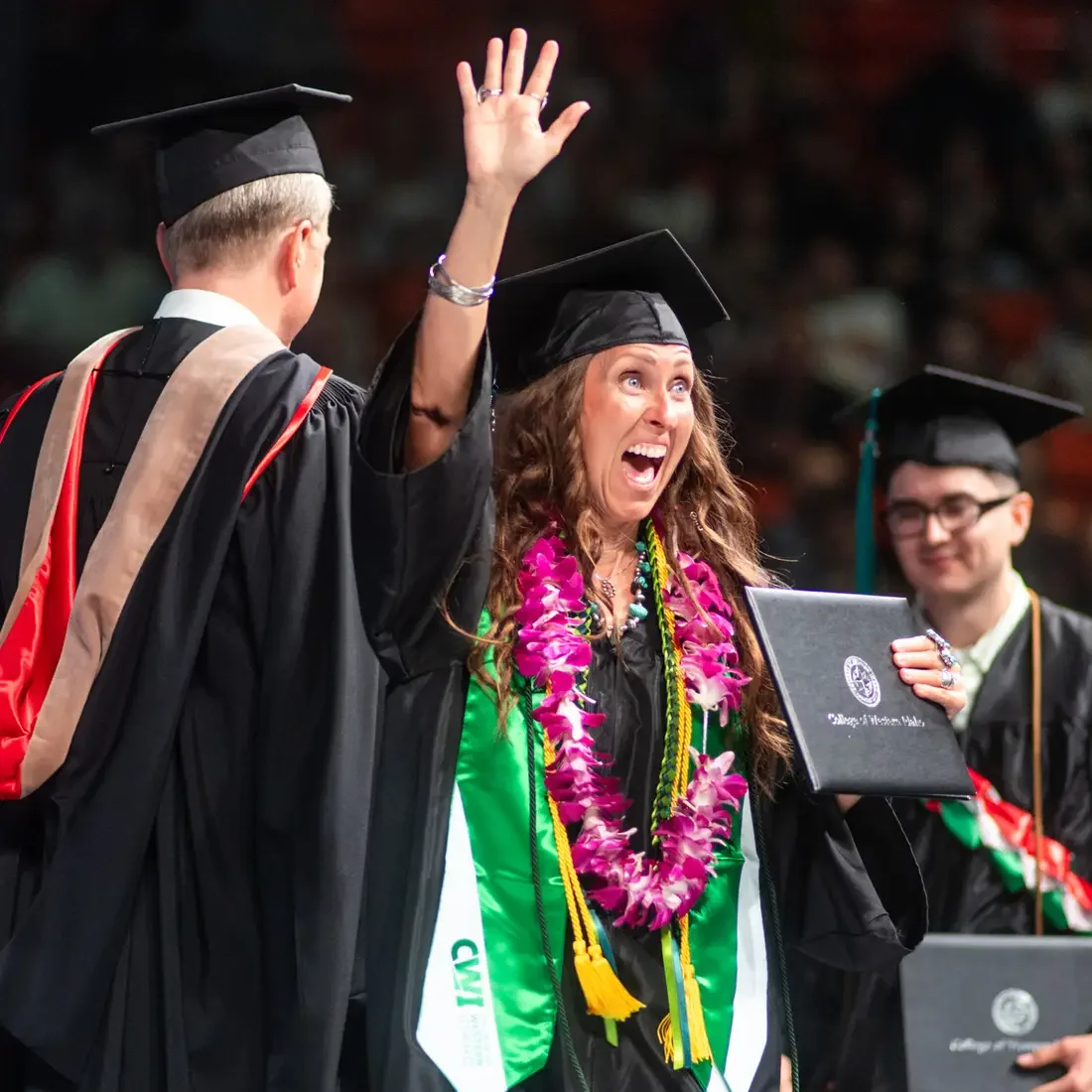 A graduate celebrates receiving her degree.