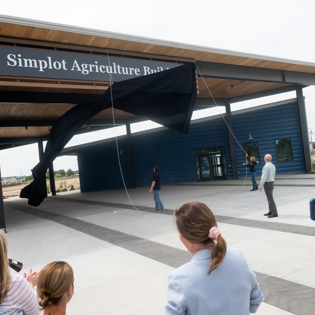 A new sign is unveiled on a building.
