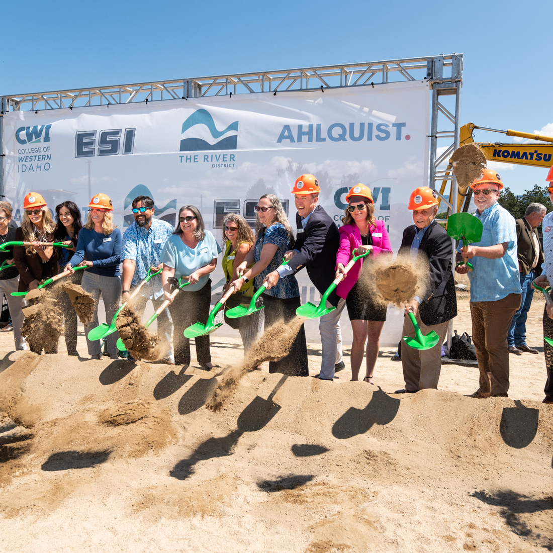 Dignitaries stand with shovels for a ceremonial groundbreaking.