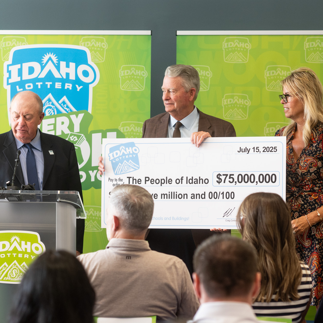 Idaho Governor Brad Little accepts a ceremonial check for $75M from the Idaho Lottery Commission.