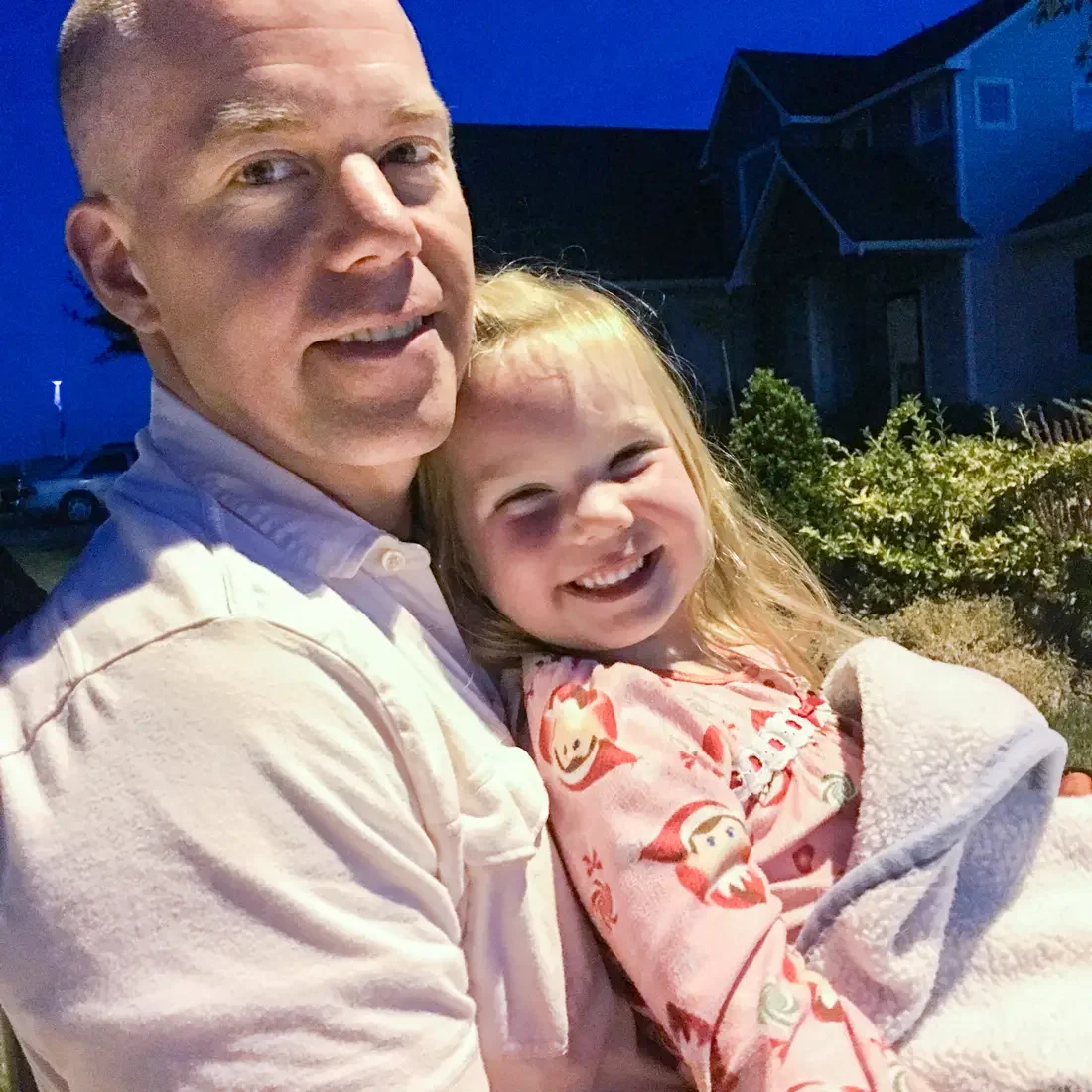 A photo of a man holding a smiling child.