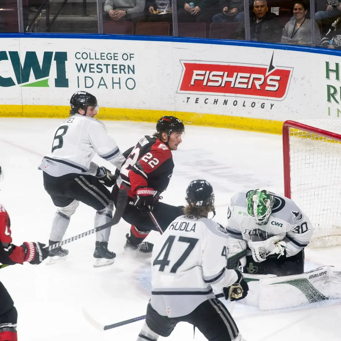 Hockey players race for the puck.