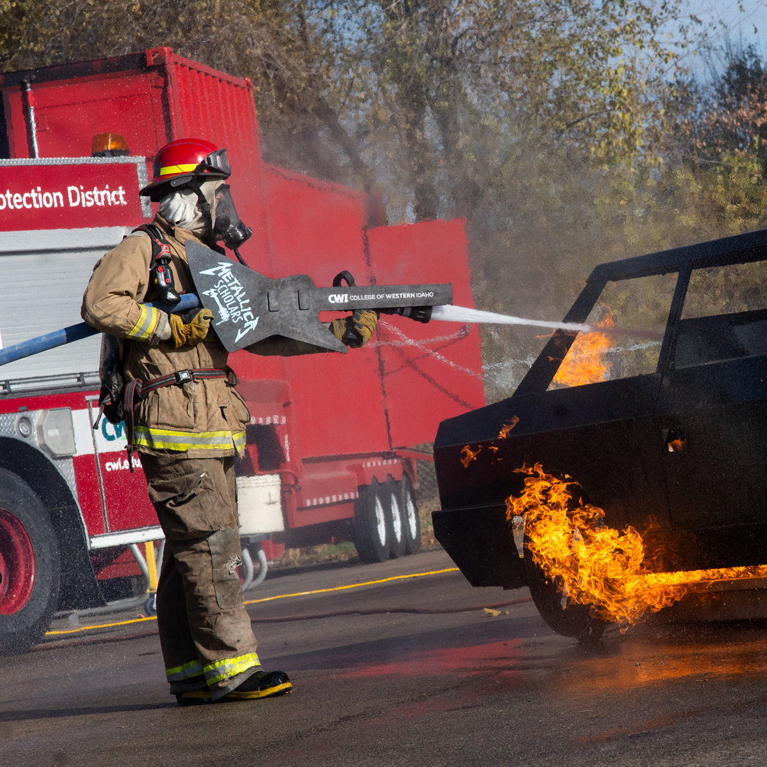 A firefighter puts out a simulated car fire.