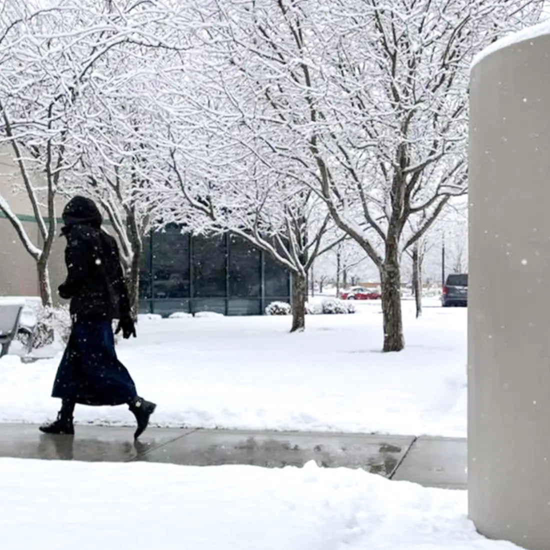 Student walking into the Ada County Campus Pintail Center in the snow