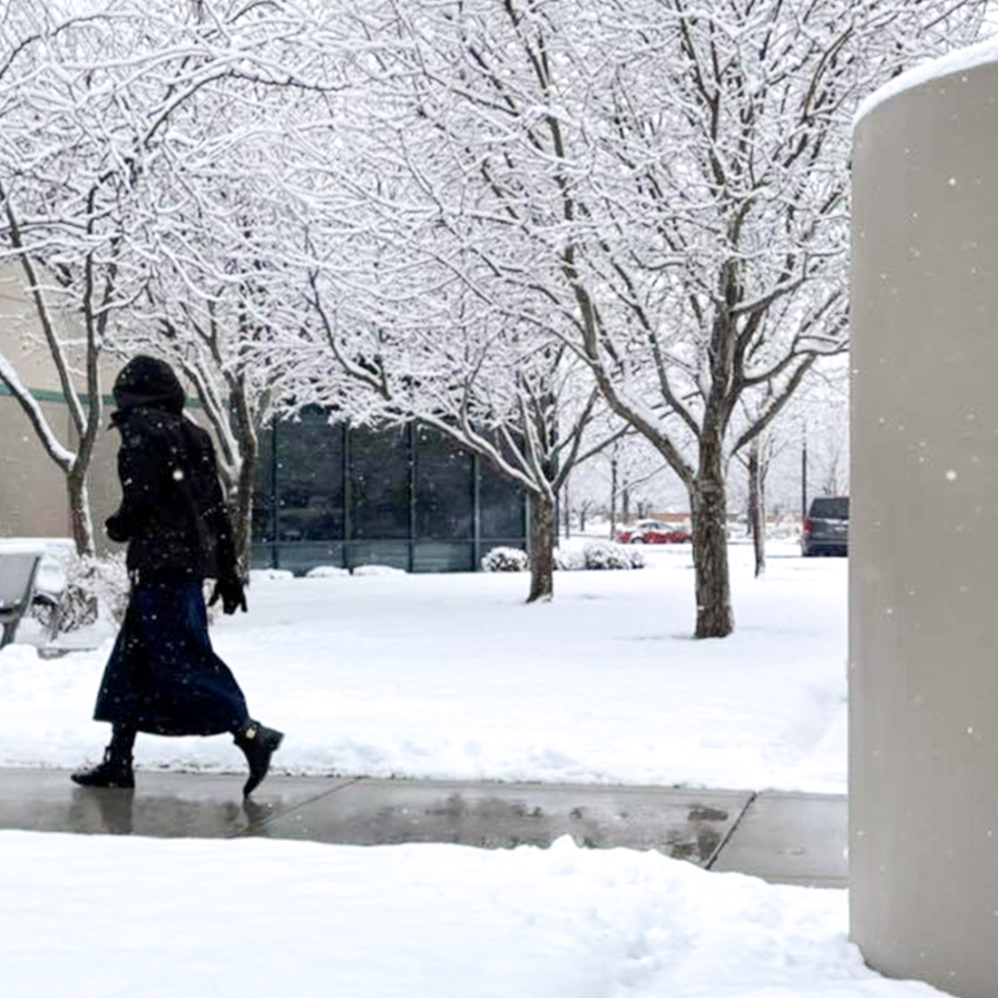 Student walking into the Ada County Campus Pintail Center in the snow