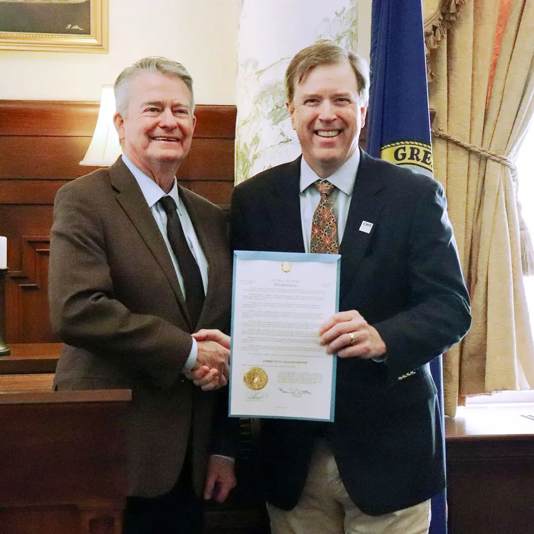 CWI President Gordon Jones shakes the hand of Idaho Governor Brad Little after being presented with a ceremonial proclamation. 