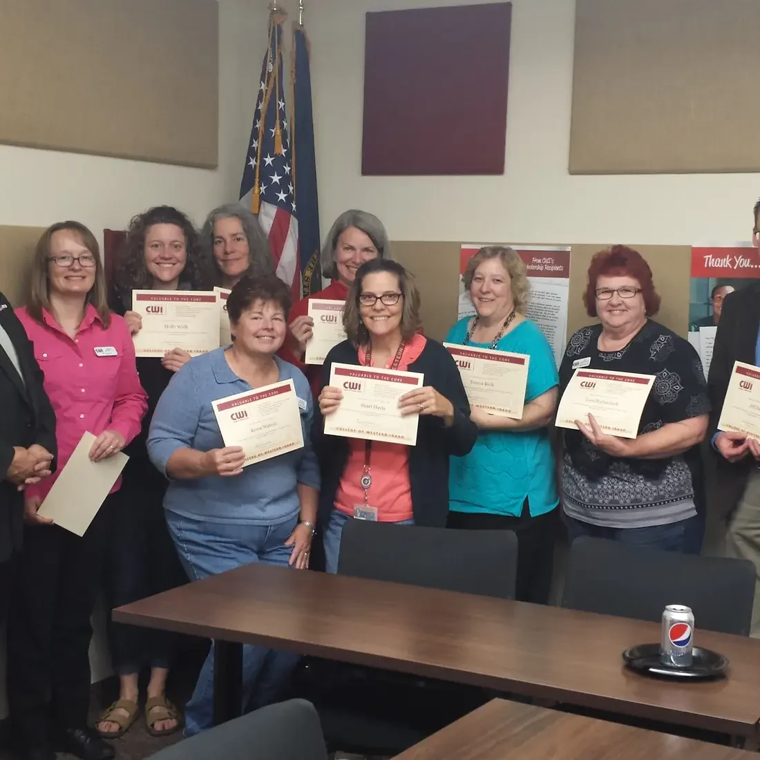 Employees standing with the Bert Glandon being recognized
