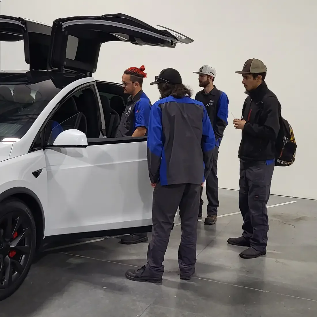 Students looking at a Tesla