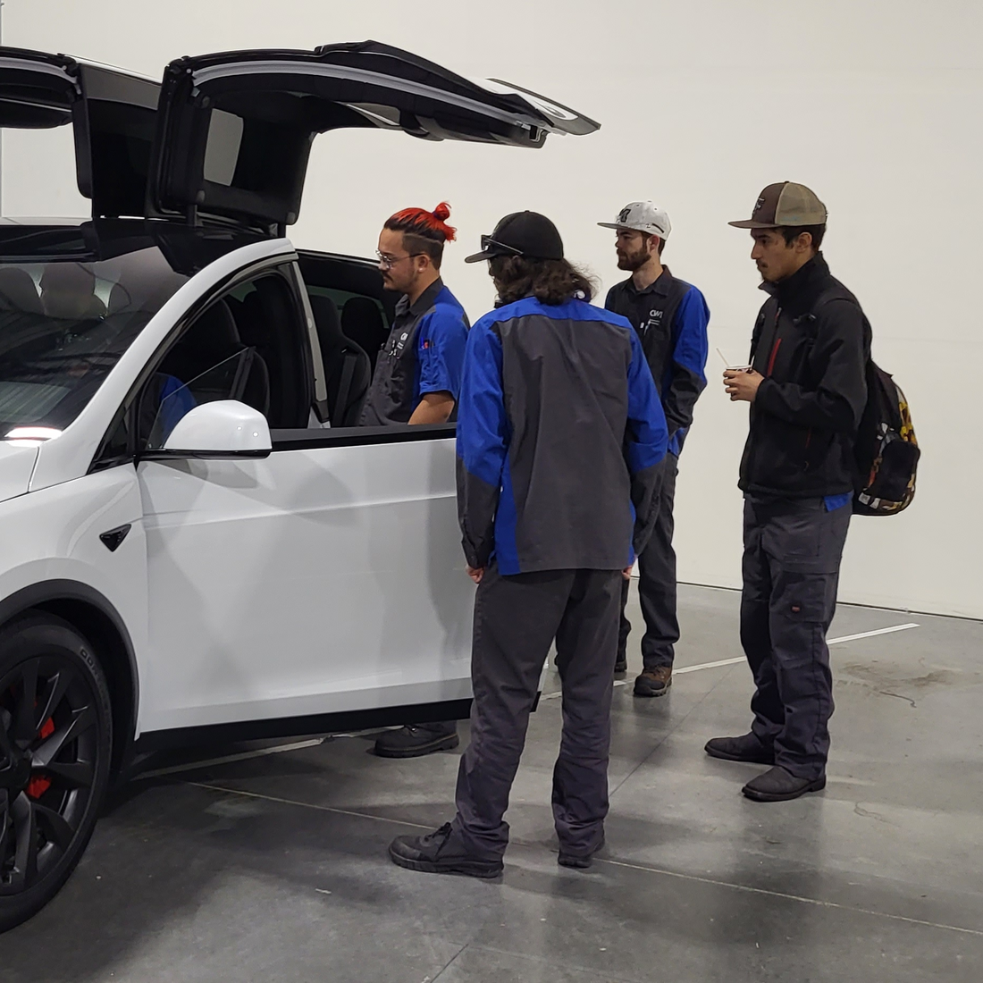 Students looking at a Tesla