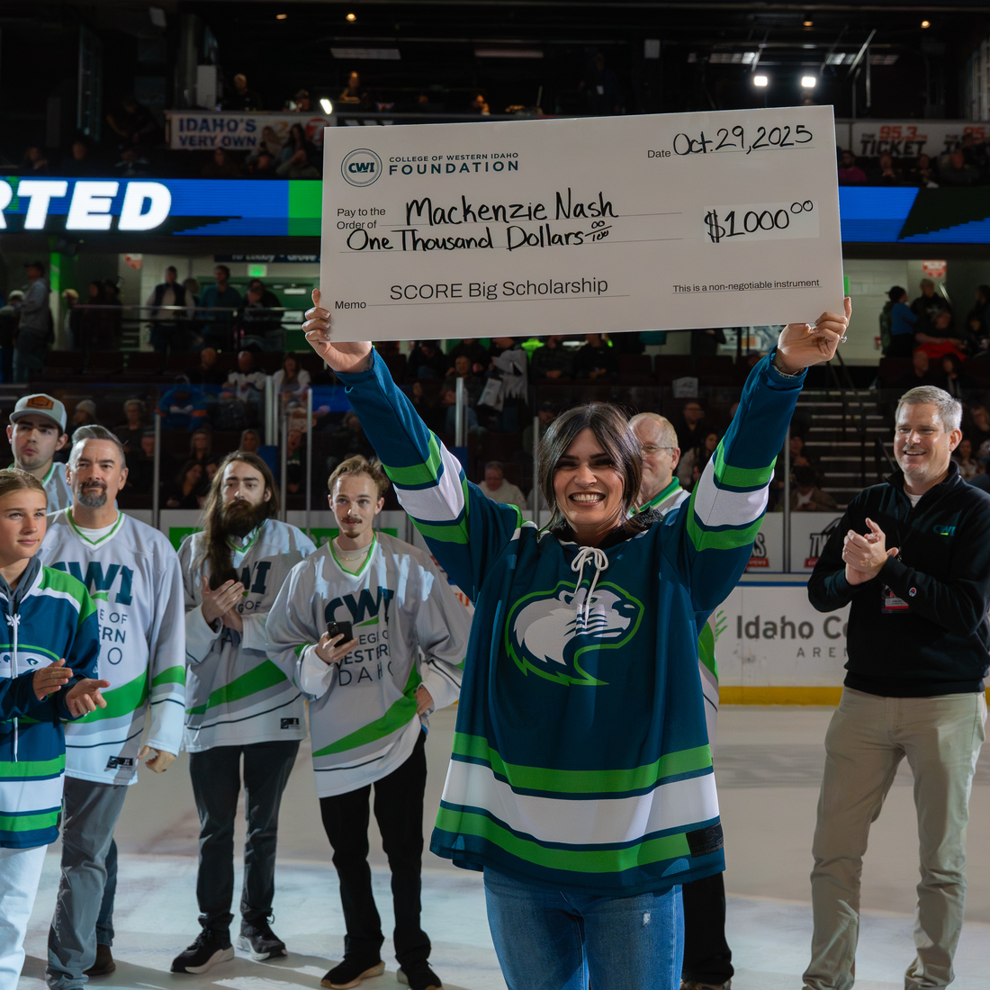 Mackenzie Nash holds a giant check on the ice