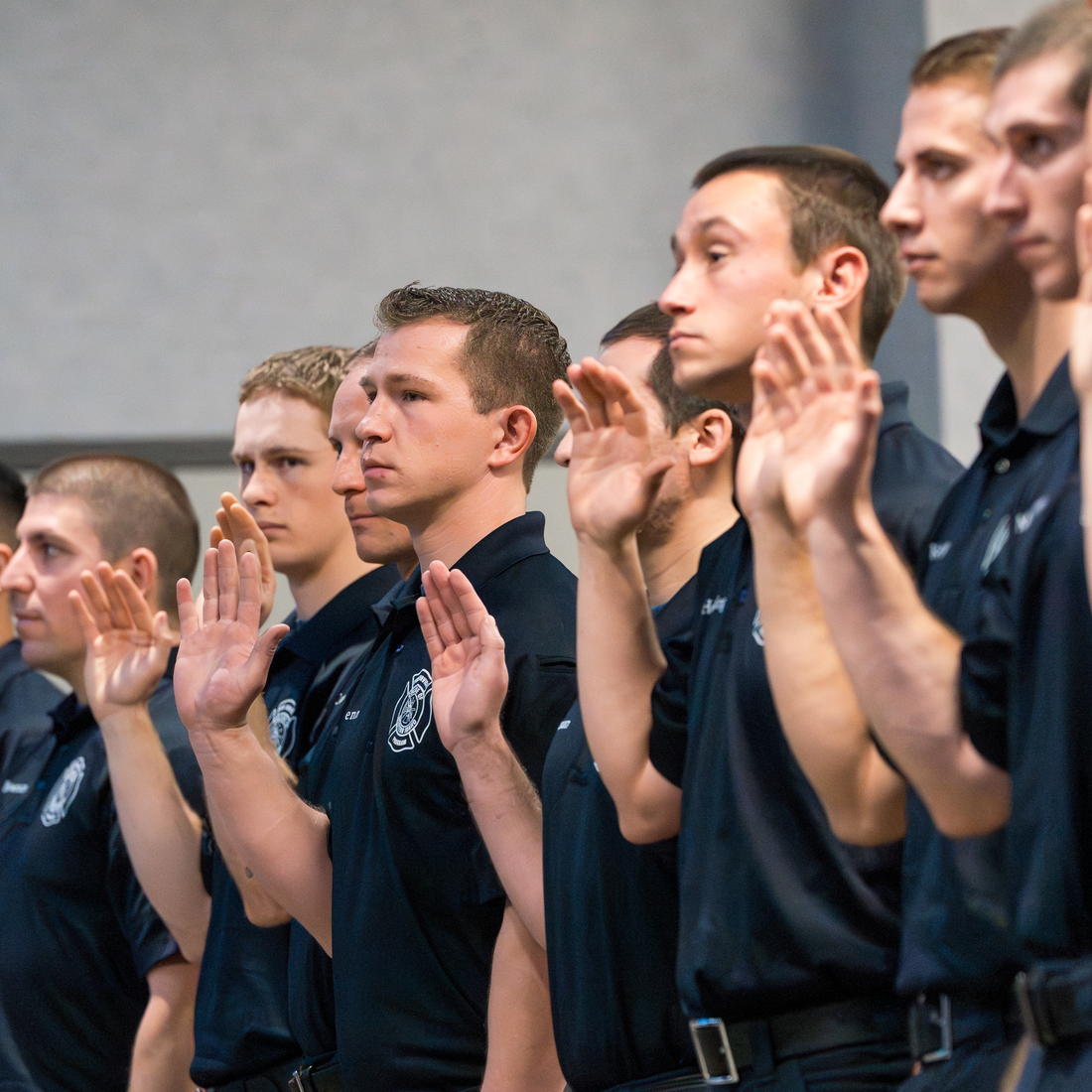 Graduates raising their hand and taking an oath