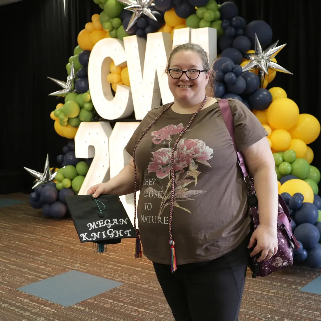Graduate holding newly decorated cap