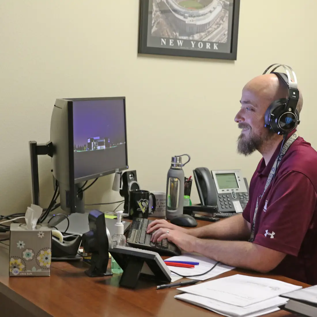 employee with headphones at a computer