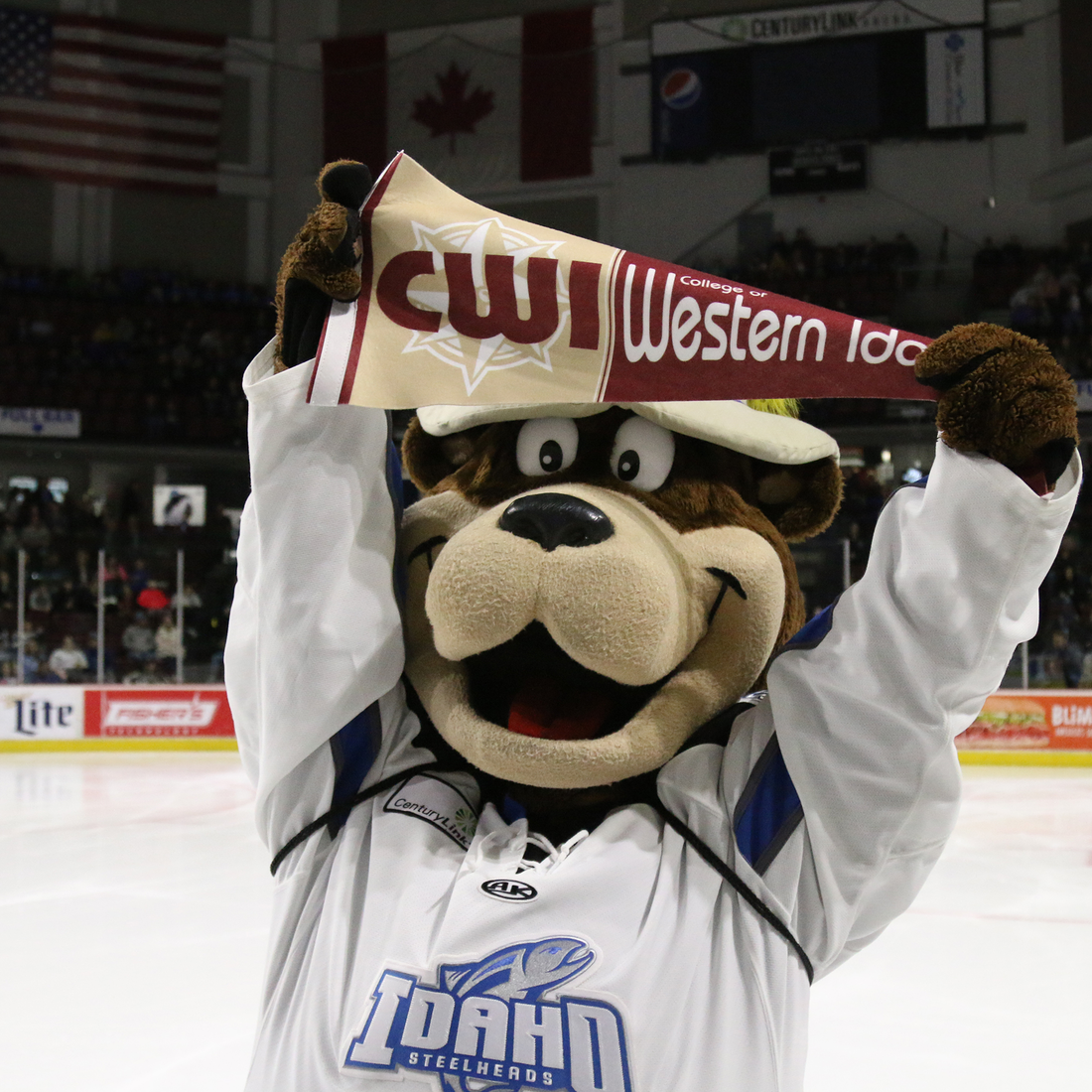 Idaho Steelheads Mascot, Blue, holding a CWI pennant