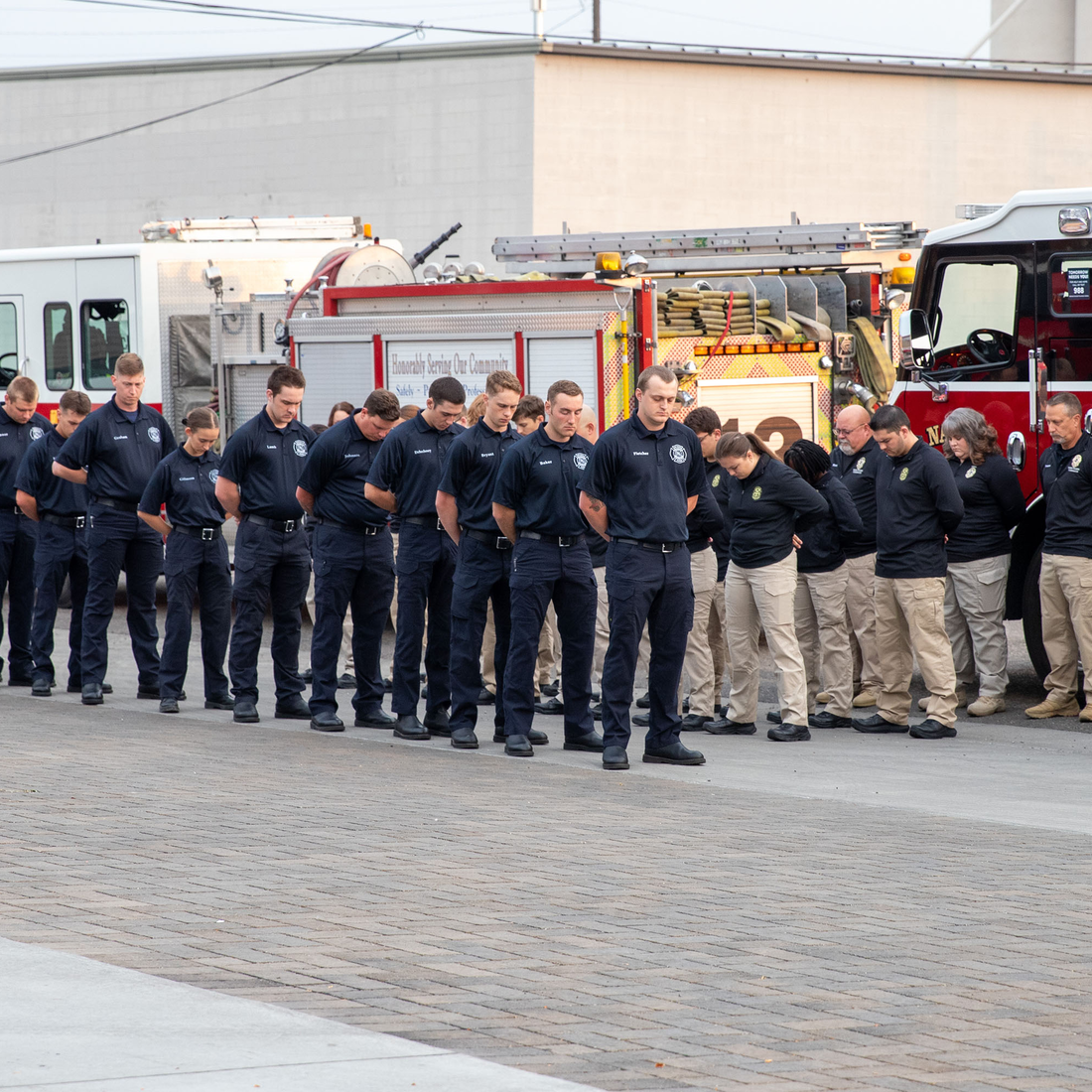 Fire and Police first responders bow their heads in remembrance of 9/11.