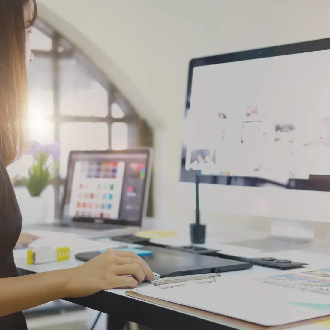 Student designing a logo on a desktop computer