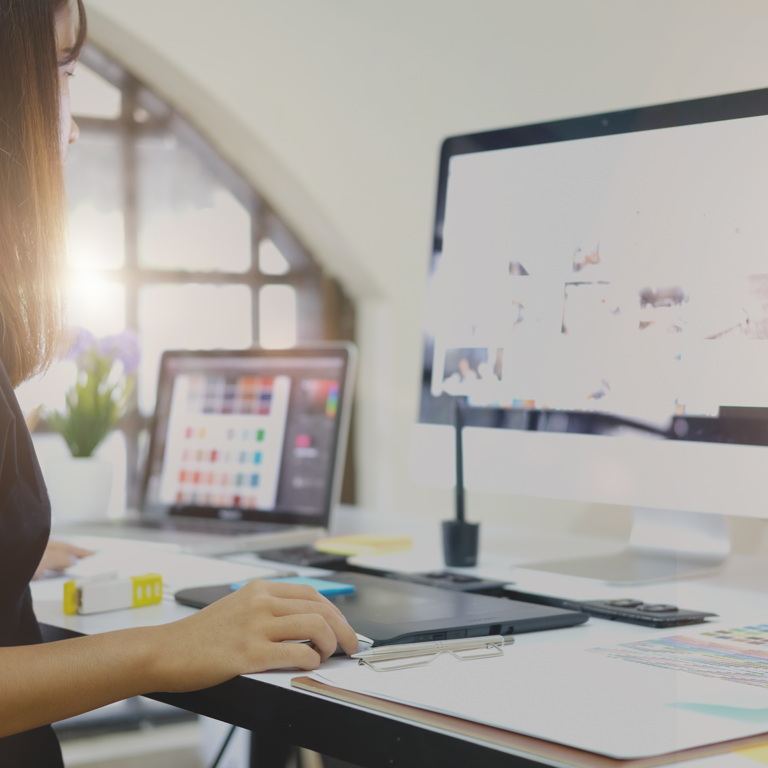 Student designing a logo on a desktop computer