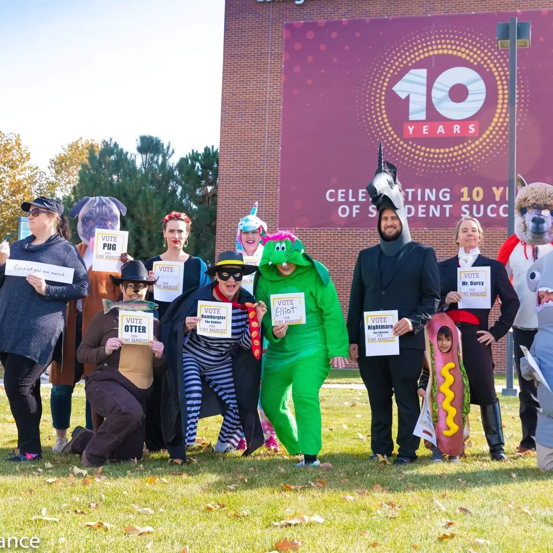 Employees dressed up in Halloween costumes outside the Nampa Campus Academic Building