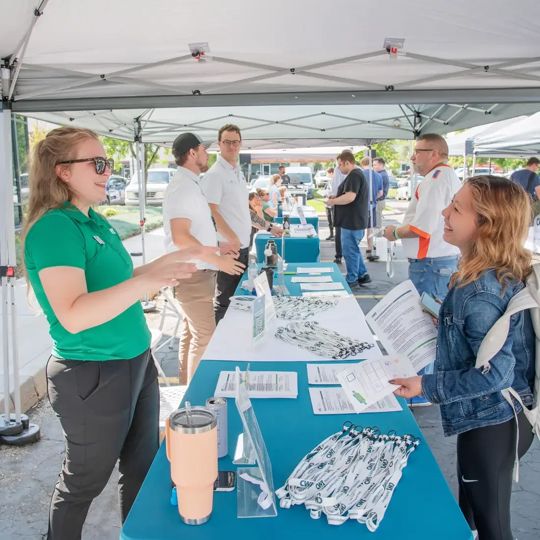 Staff and student laughing near table