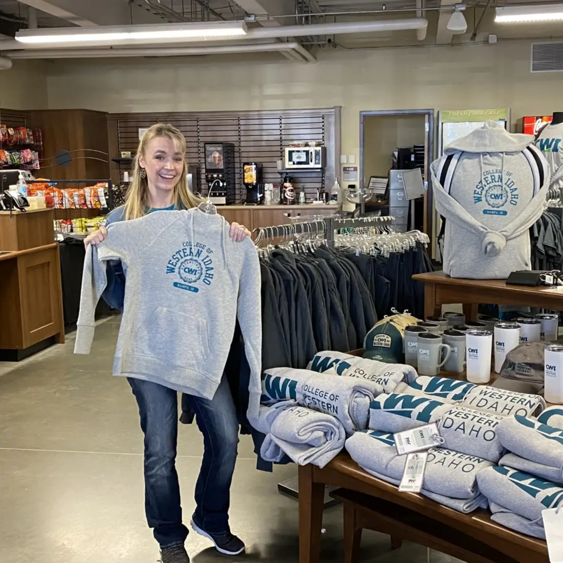 Individual showing off a CWI sweatshirt sporting the Colleges new brand