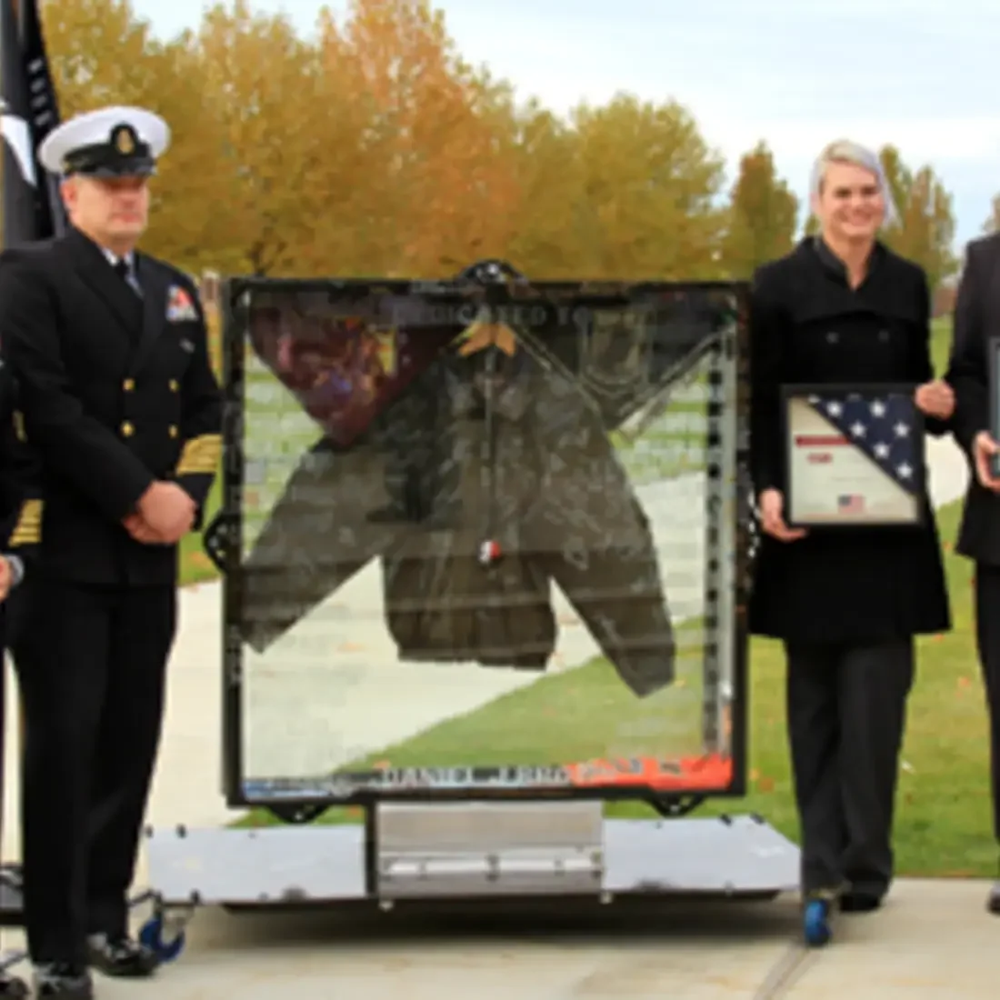Veterans with Jacket in shadow box at Veterans Day event