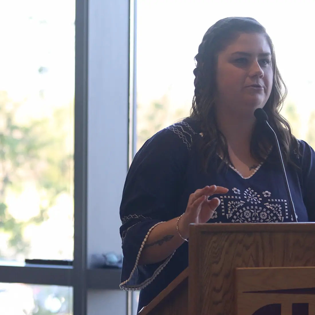 Female student speaking from a podium