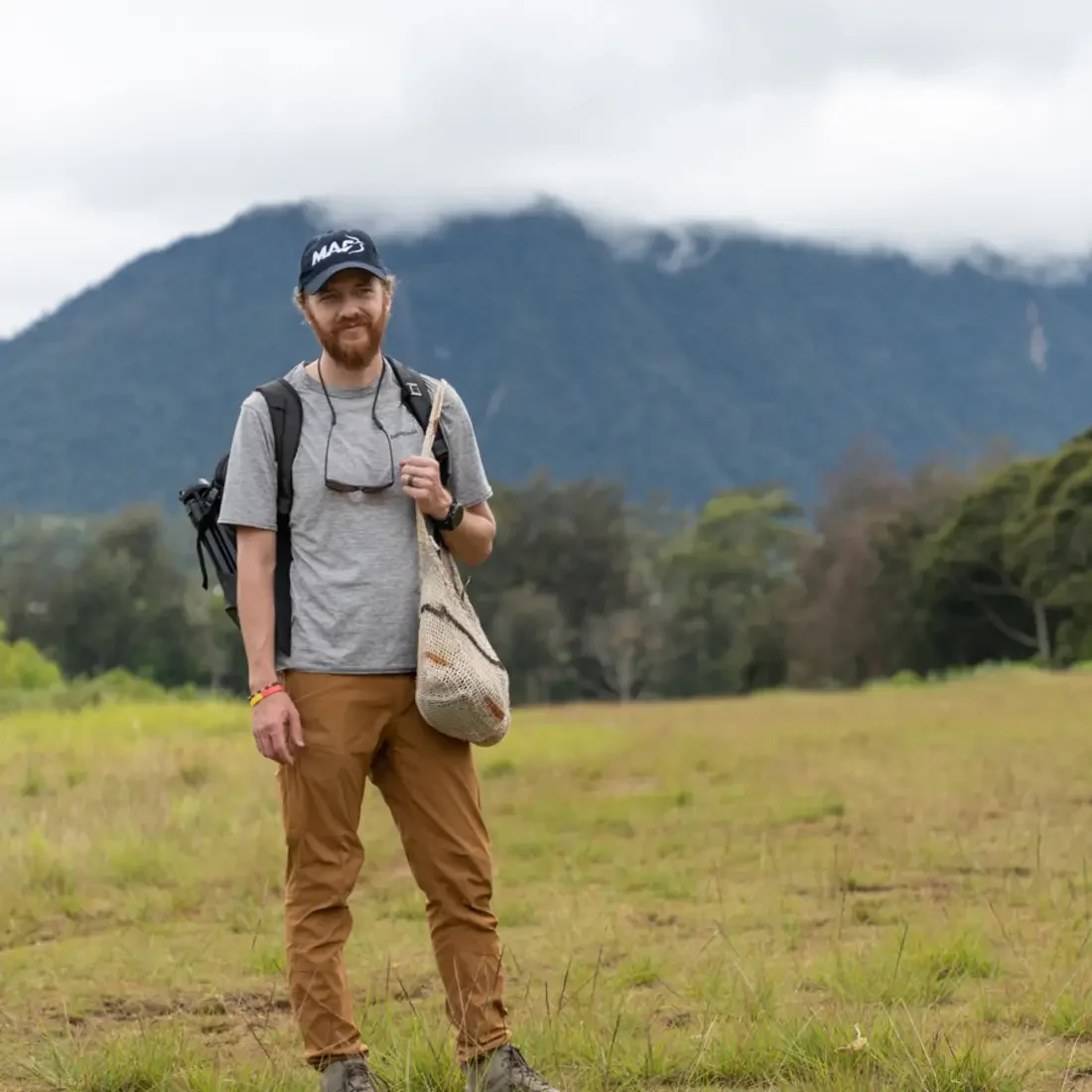 A photographer stands in a field.