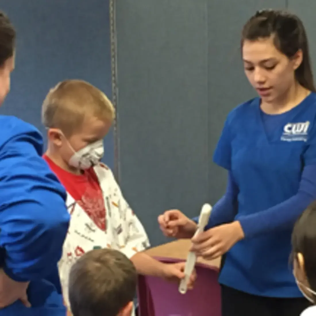 Dental Assisting students demonstration with kids.