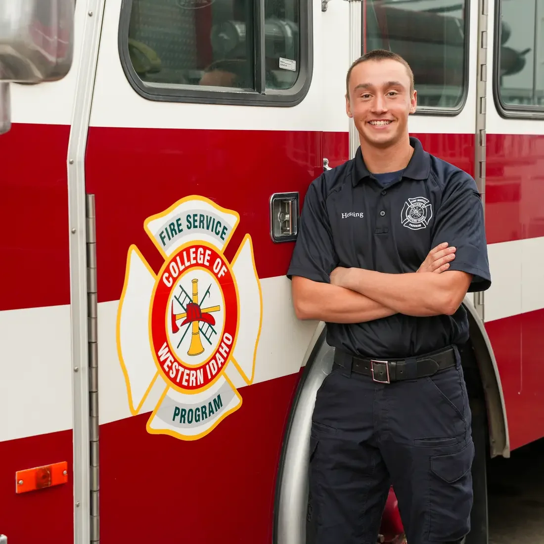 Kemper Hessing stands in front of a CWI fire truck
