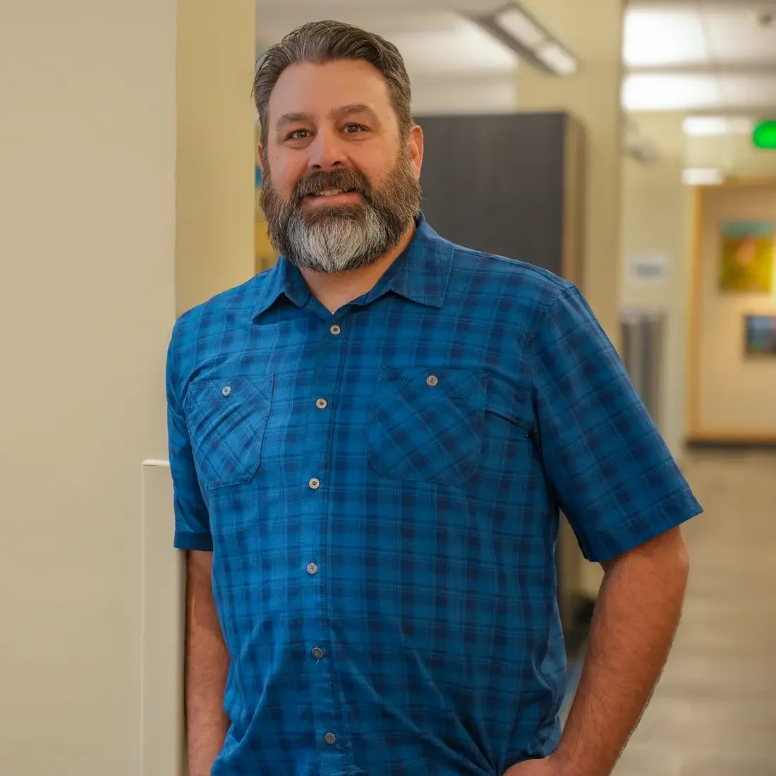 Person stands next to pillar and table