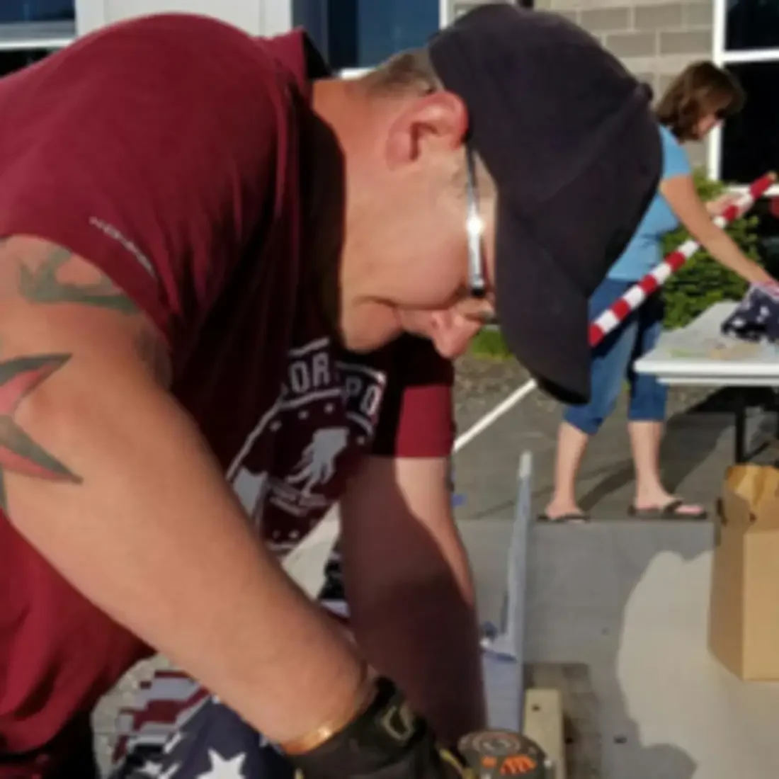 CWI student Dallas Hulsey helps assemble flags for the Eagle Field of Honor.