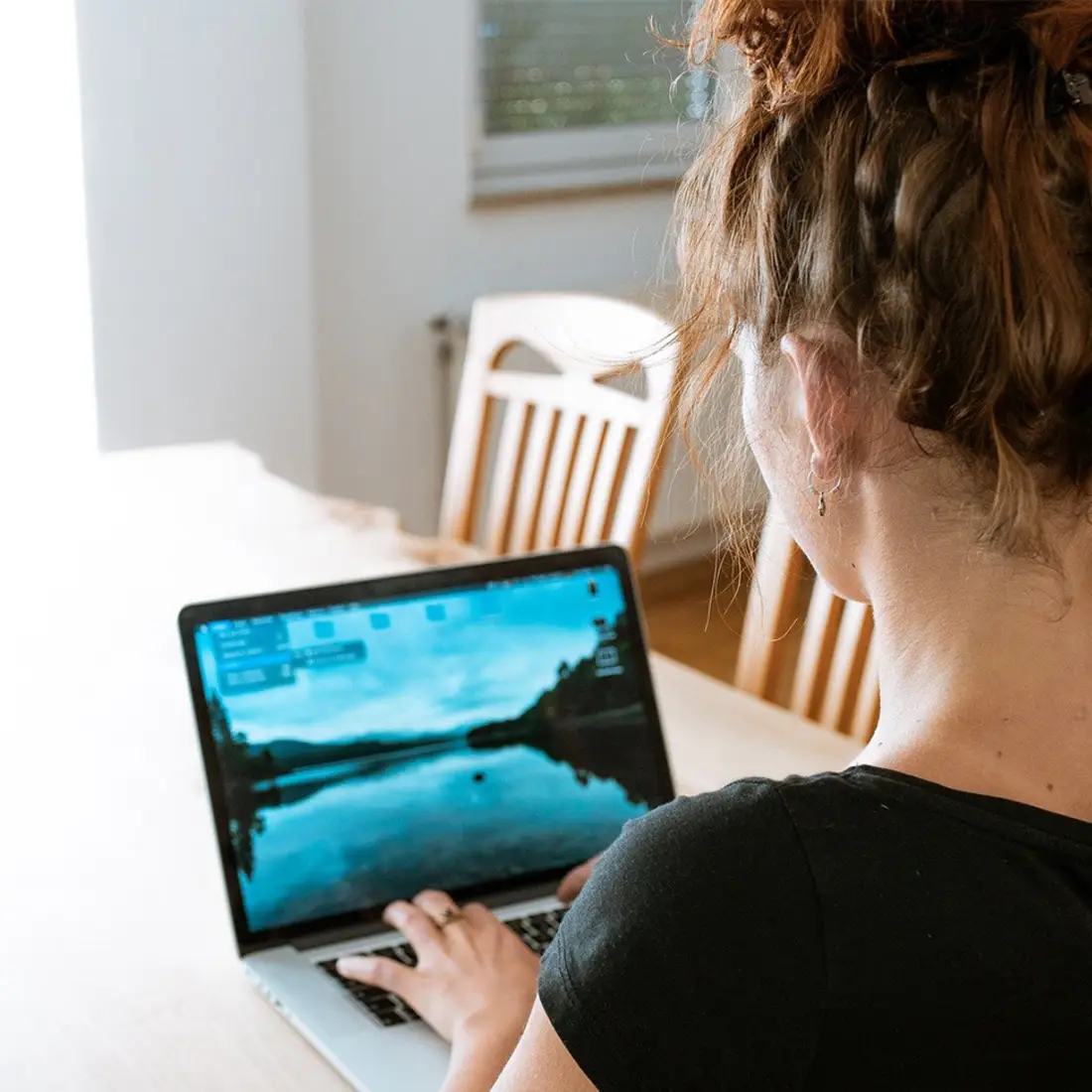 Woman on a laptop at her dining room table