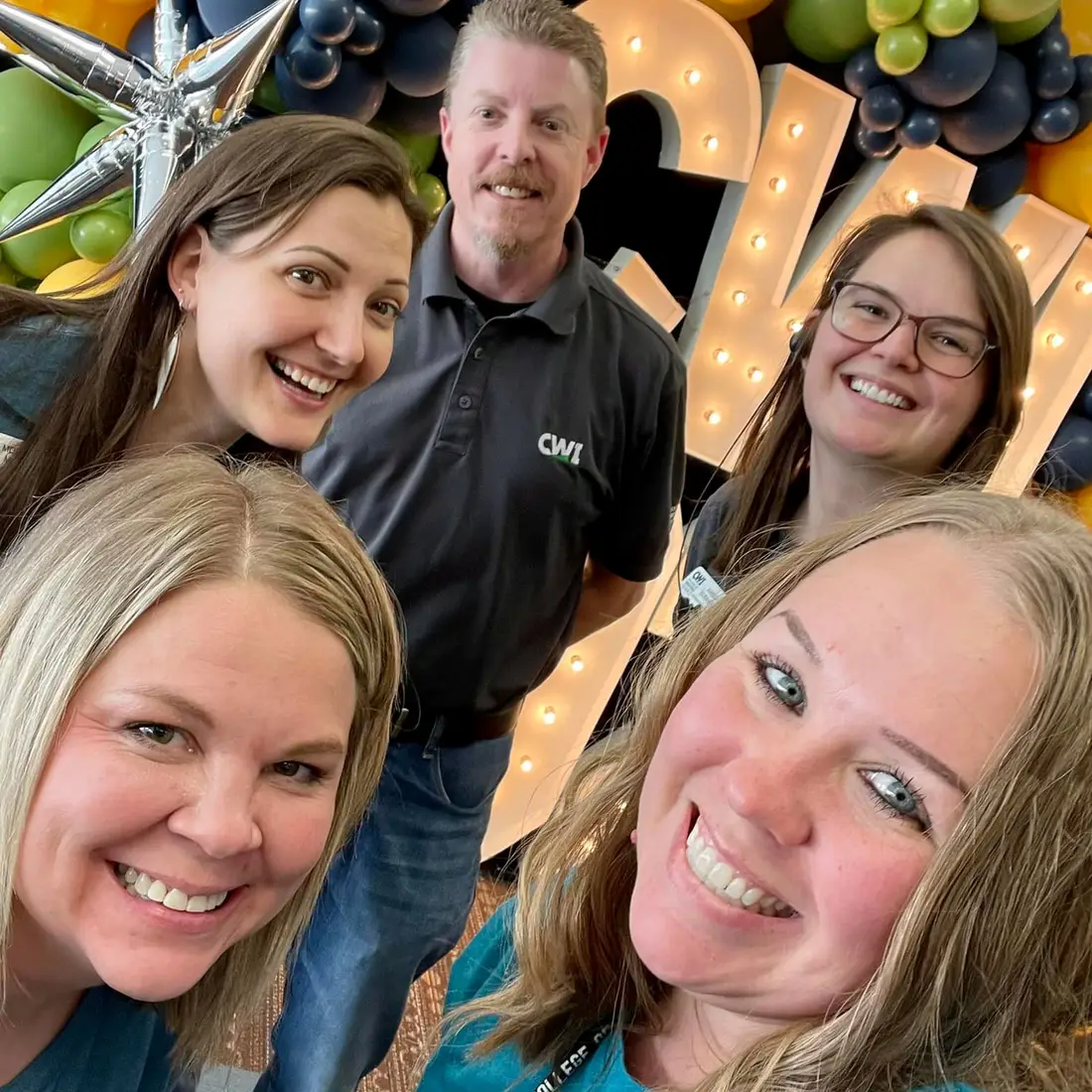 Employees posing together for a photo during Grad Fest