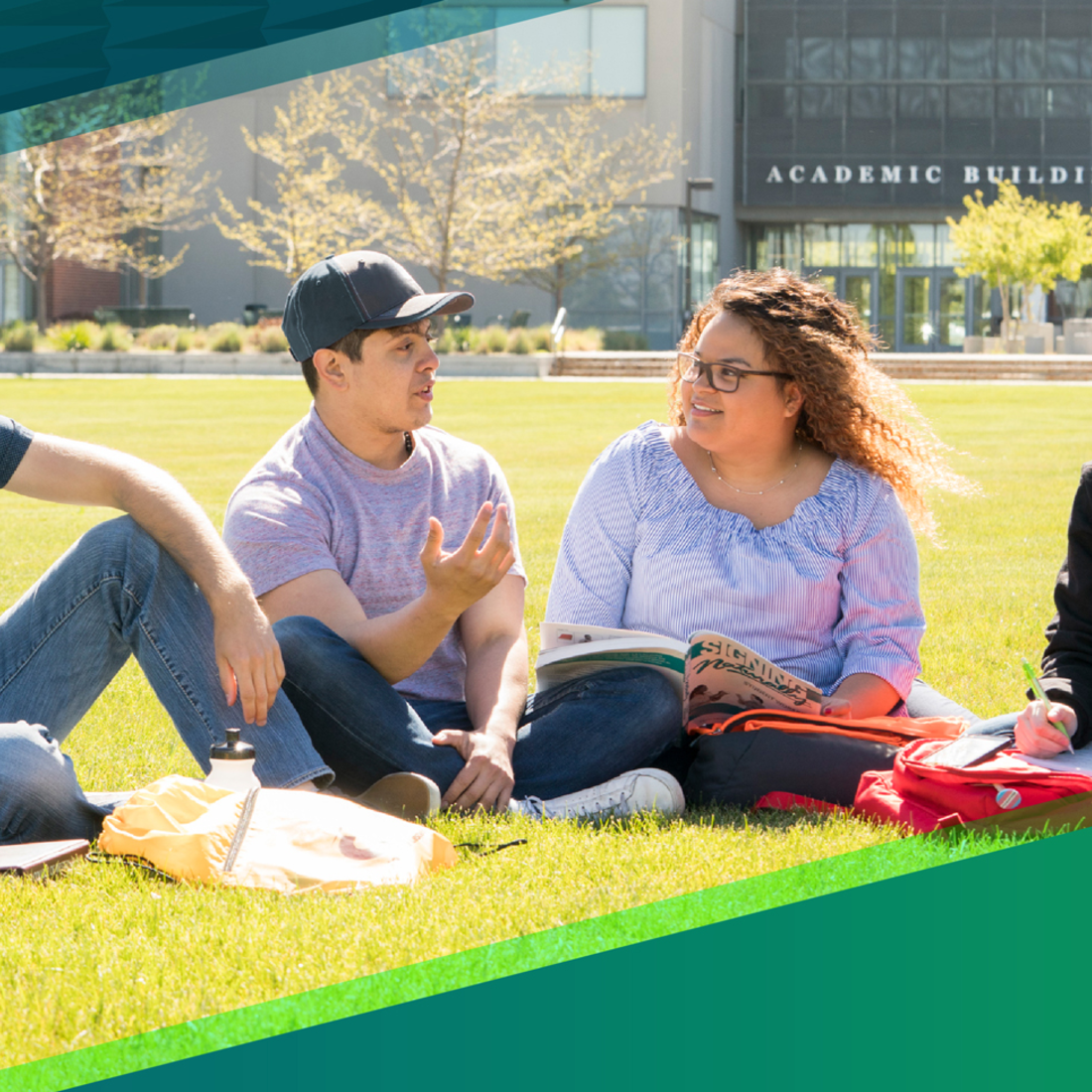 Students sitting on the lawn in front of the Nampa Campus Academic Building talking